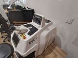 a desk with a computer and a chair in a room