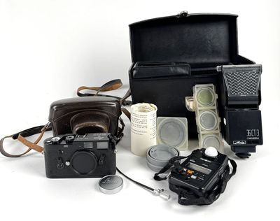 a black case with a camera, a camera, and other items on it