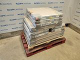 a stack of books on a pallet in front of a wall