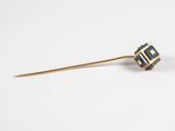 a gold stick with a black and white design on it