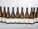 six bottles of wine are lined up in a row on a table