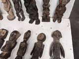 a lot of wooden figurines that are sitting on a table
