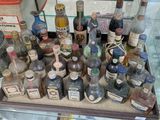 many bottles of alcohol on display in a glass case