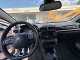 the interior of a car with a steering wheel and dashboard
