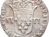 a silver coin with a crown on top of it