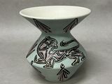 a small vase with a design on it on a table