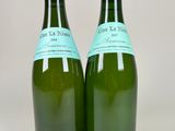 two bottles of wine are sitting next to each other on a table