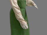 an image of a mannequin wearing a green skirt and white shirt