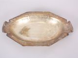 a silver plate on a white table with a white background