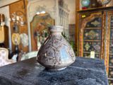 a vase sitting on top of a table in a living room