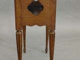 a small wooden table with a bowl on top of it