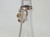 a small glass bottle that has a small bottle inside of it