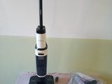 a vacuum that is sitting on a table next to a bag