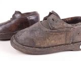 pair of old worn shoes on a white background