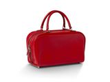 un sac à main rouge posé sur une surface blanche