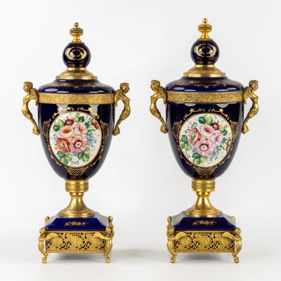 pair of blue and gold vases with floral designs on them