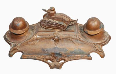 an old brass plate with a baseball and glove on top of it