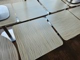 tables and chairs are lined up in a row on a wooden floor