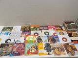 a lot of books on a table with a clock on it