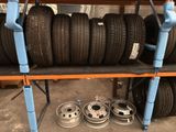 many tires on a shelf in a garage
