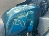 a blue motorcycle parked on the side of the road