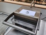 a machine that is sitting on a conveyor belt in a restaurant