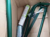 a box with a green handle and a spray bottle in it