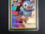 an image of a pokemon card with a picture of a girl and a penguin