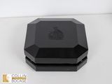 a close up of a black box on a white surface
