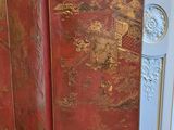 a red room divider with gold leaf designs on it