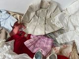 a lot of clothes and shoes that are on a bed