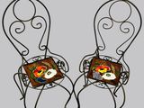 pair of wrought garden chairs with colorful tile backs