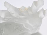 a close up of a white vase with a flower in it