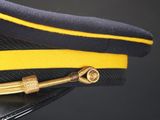 a close up of a hat with a yellow ribbon on it