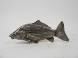 an antique silver fish figurine on a white background