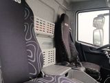 two seats in the back of a truck with a laptop on the seat