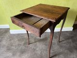 a small wooden table with a drawer on top of it