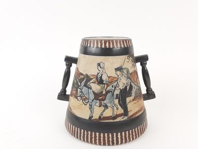 a vase with a picture of a man riding a horse on it