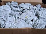 a cardboard box full of clothes that is sitting on the floor