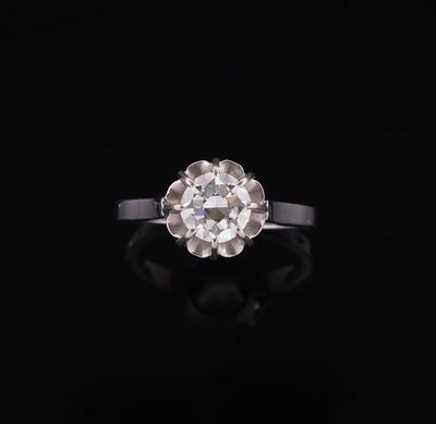 an old cut diamond ring on a black background
