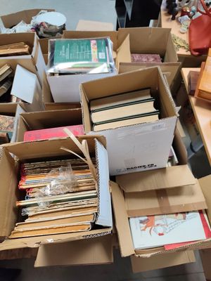 many boxes of books on a table in a room