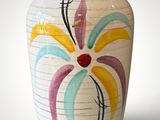 a vase with a colorful flower painted on it