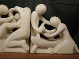 sculpture of a man and a woman sitting on a rock