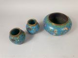 three vases that are sitting on a table