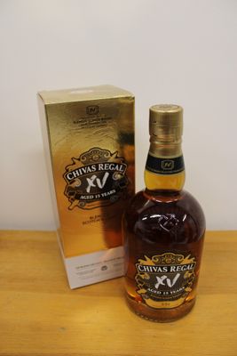 bottle of chivas regal xxv next to box on wooden table