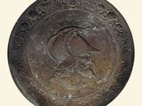 an old bronze plate with a bird on it