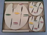 three plates in a box that have different designs on them
