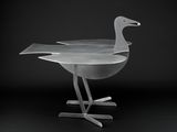 an image of a metal bird on a stand against a black background