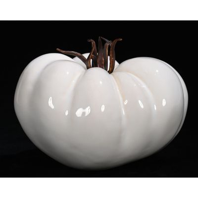 a white ceramic pumpkin shaped object on a black background