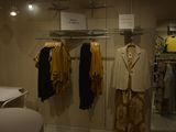 a lot of clothes hanging on a rack in a room